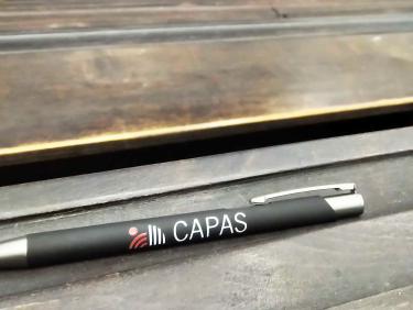 A pen with the CAPAS logo on top of a desk
