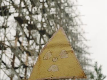 Radioactive warning sign in front of a large metal structure
